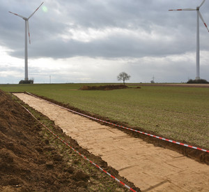 Baustelle mit Windrädern im Hintergrund
