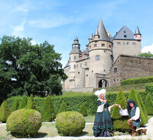 Zwei Barock kostümierte Personen vor Schloss Stolzenfels